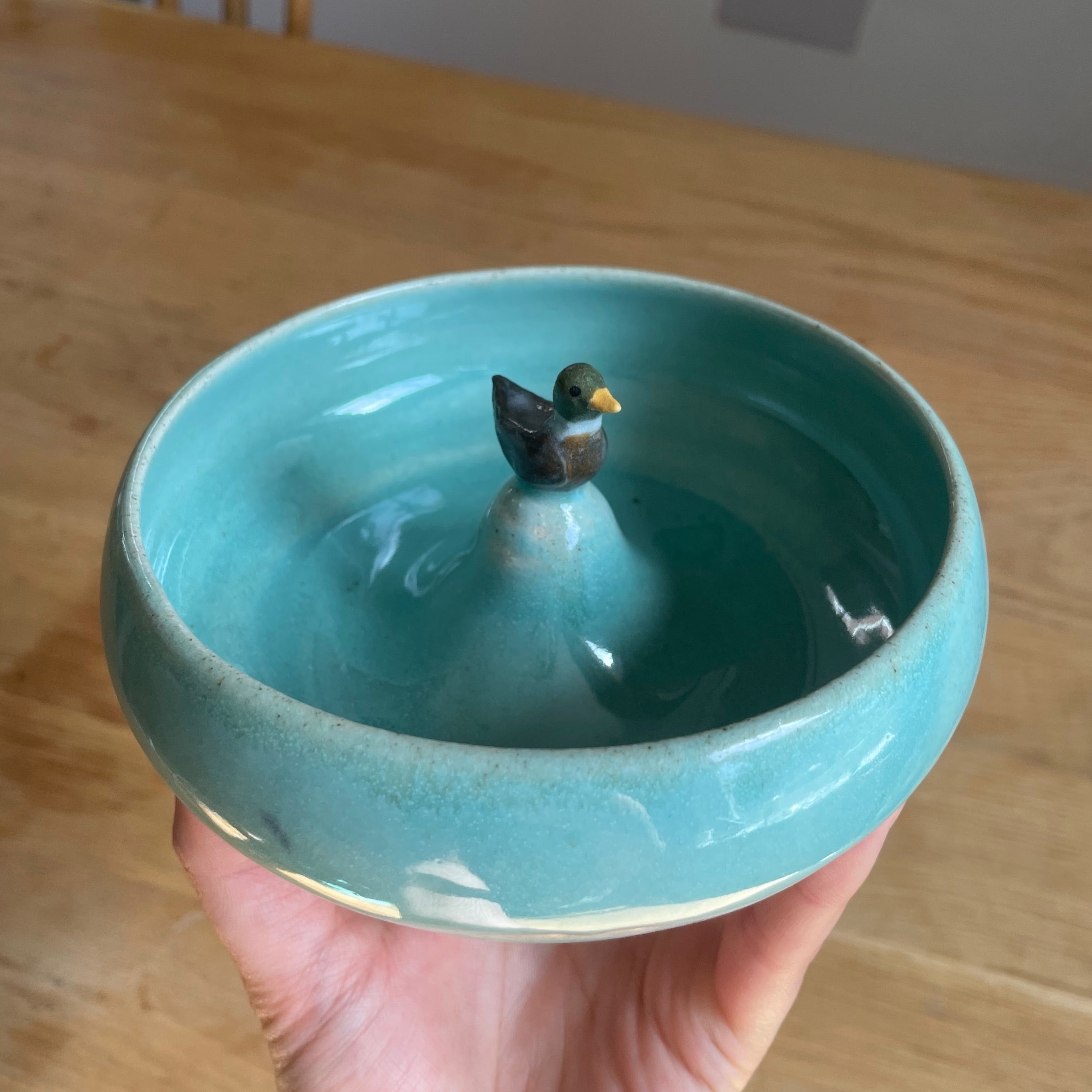 Turquoise ceramic bowl with a duck design