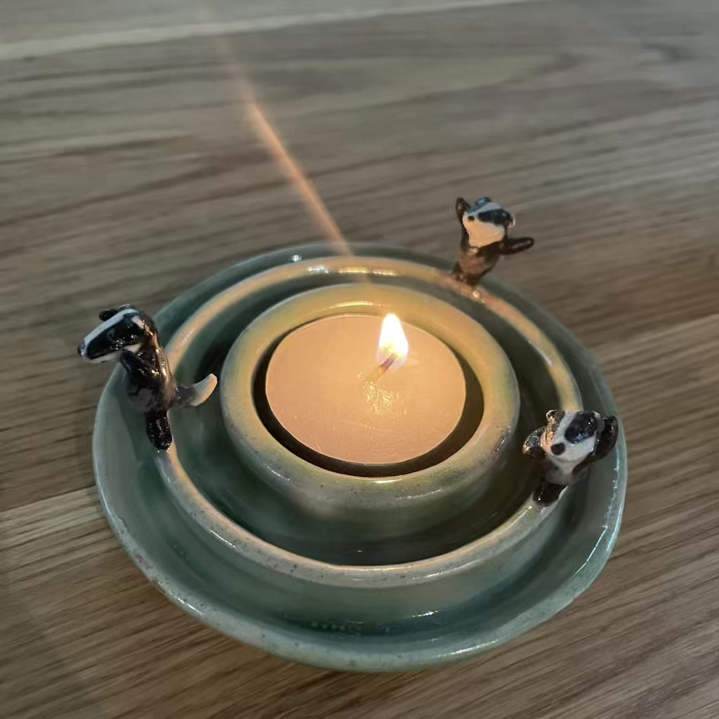 Dancing badgers tea light holder