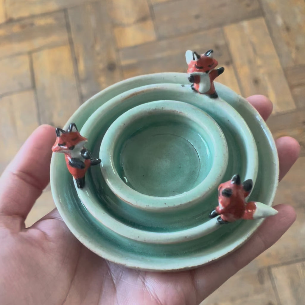 Dancing foxes candle holder